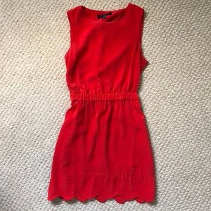 Red dress with cinched waist and scallop bottom